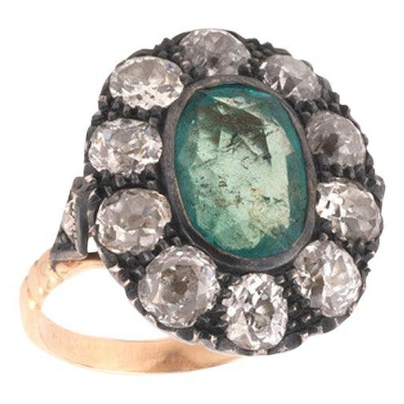 An Emerald And Old Cut Diamond Cluster Ring