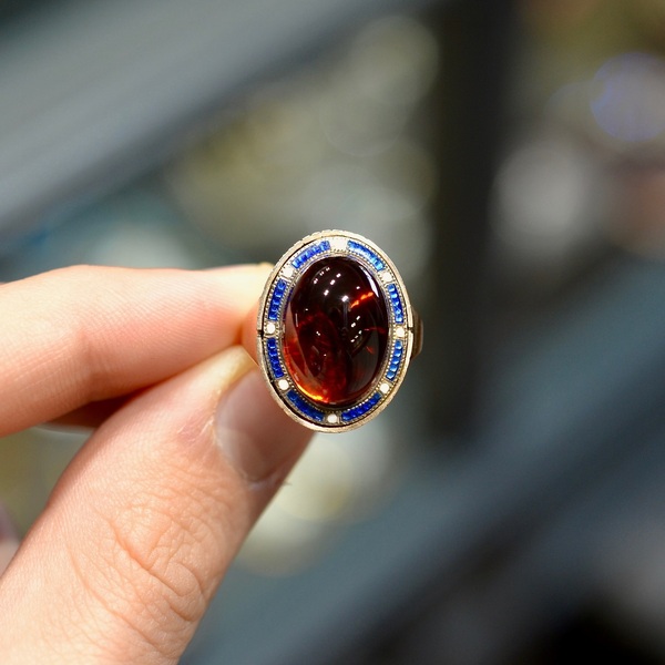 A Late 18th Century Garnet And Enamel Cluster Ring #bernardo 

The oval cabochon almandine garnet of approximately 5ct within a surround of blue and white enamel. 
The oval-shaped cabochon-cut garnet measuring approximately 9x8mm.