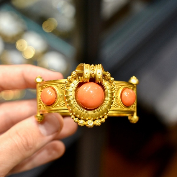 Archaeological Revival Gold And Coral Bangle Bracelet 1860’s #bernardo 

Bracelet decorated with three coral buttons in a geometric and floral pattern. 18K yellow gold setting. Width of central pattern: 3.7 cm. Gross weight: 39.77 gr.